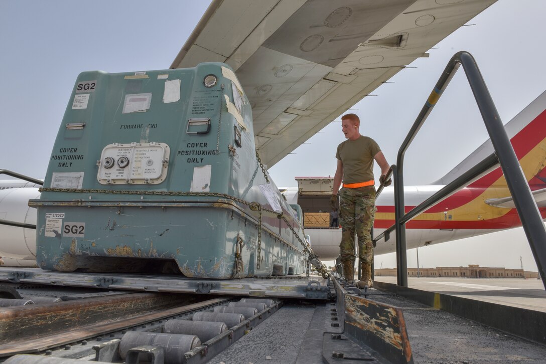 Airmen with the 8th Expeditionary Air Mobility Squadron move cargo on the flightline at Al Udeid Air Base, Qatar on April 28, 2020. The 8 EAMS Airmen support dozens of missions per day, often moving hundreds of thousands of pounds of cargo and service members around the U.S. Air Forces Central Command area of responsibility. (U.S. Air Force photo by Tech. Sgt. John Wilkes)