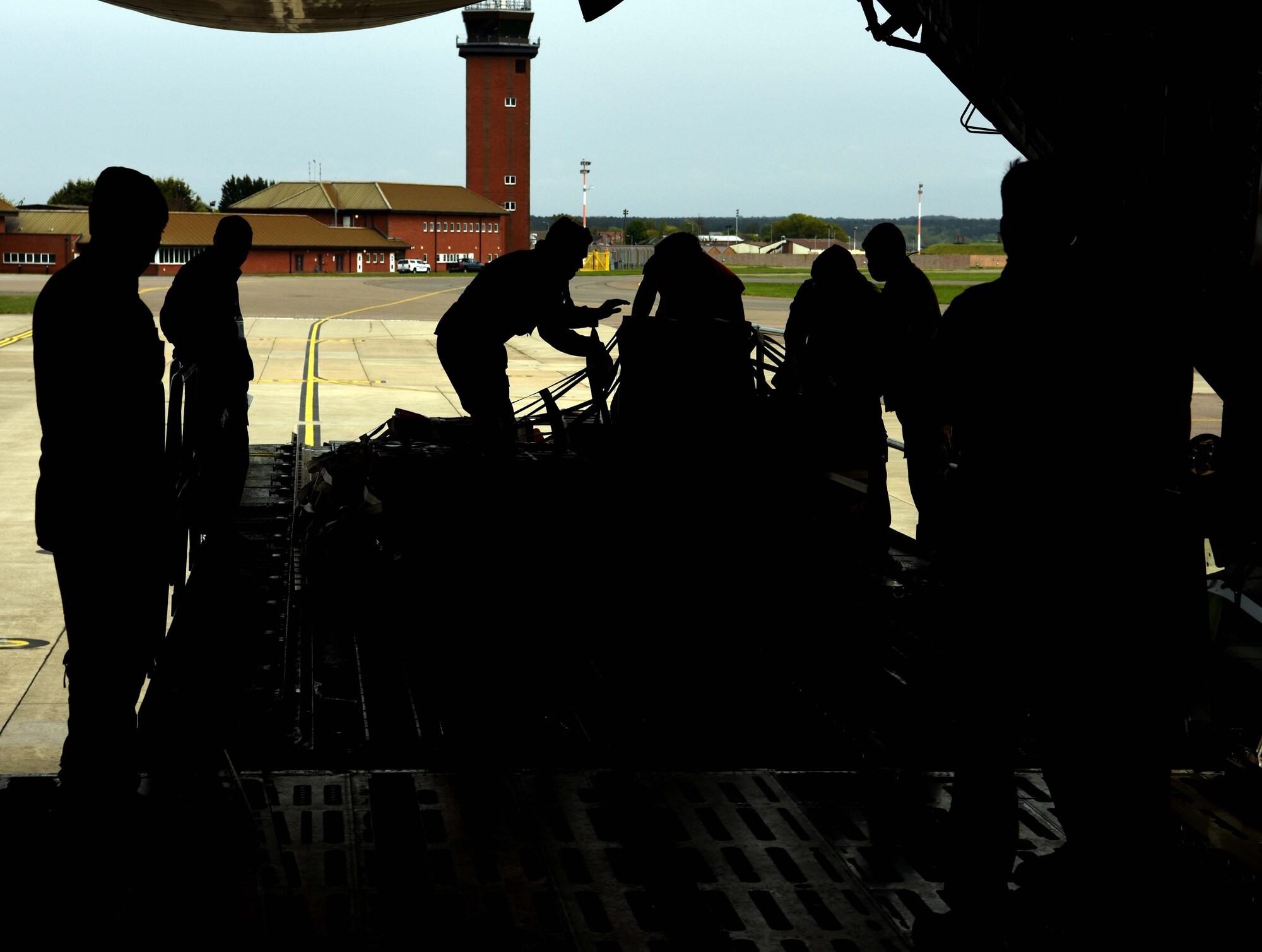 Airmen from the 9th Airlift Squadron, Dover Air Force Base, Delaware, and the 727th Air Mobility Squadron, RAF Mildenhall, England, secure pallets of cargo aboard a C-5 Super Galaxy assigned to the 9th AS during a medical cargo mission at RAF Mildenhall, April 18, 2020. The 9th AS and the 727th AMS, based at RAF Mildenhall, took part in a mission which involved delivering COVID-19 test kits and other equipment to Accra, Ghana, to be distributed throughout the U.S. African Command area of responsibility. (U.S. Air Force photo by Senior Airman Brandon Esau)