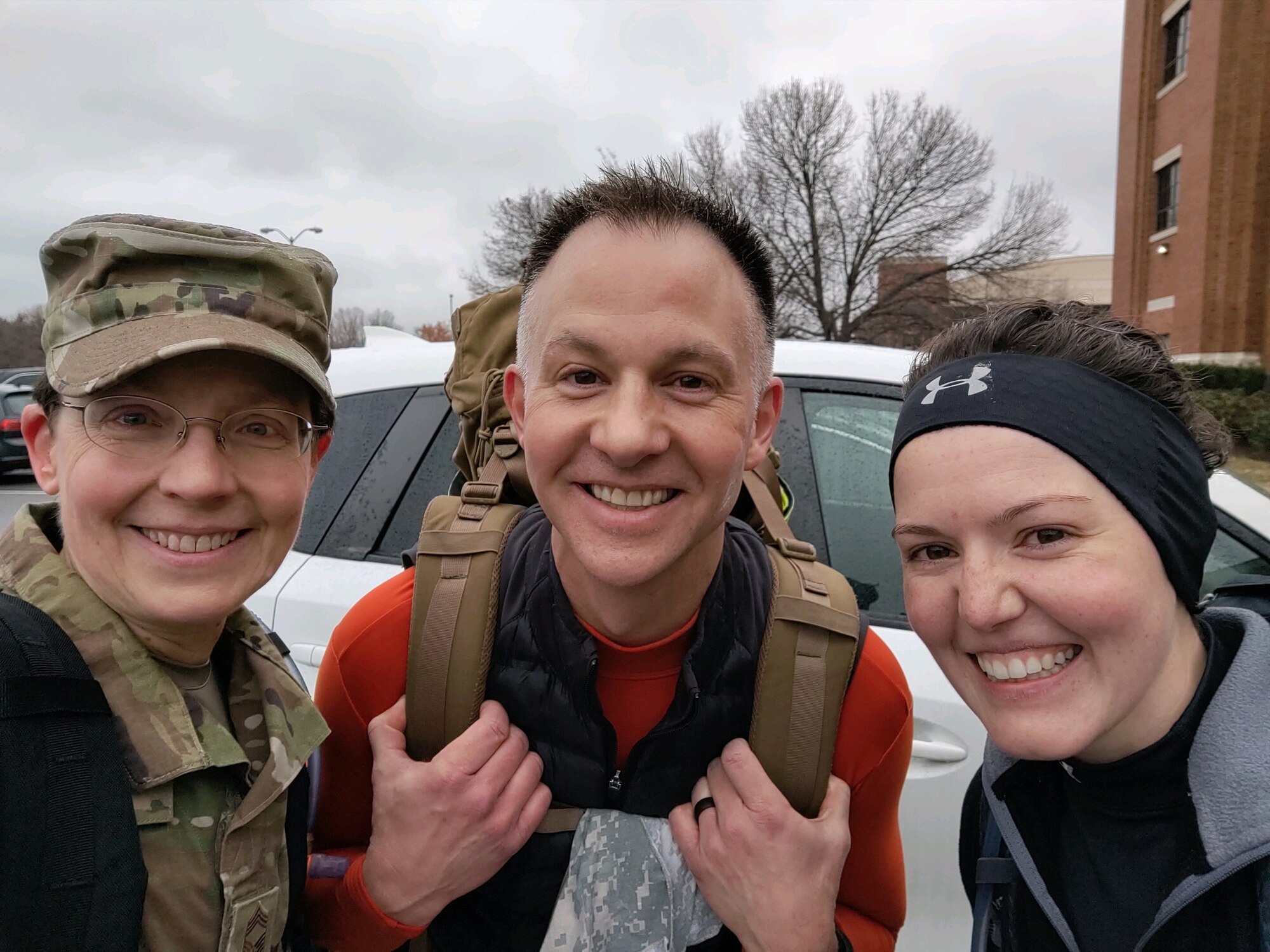 CMSgt Deborah Volker, SMSgt Bradley Bennet, and TSgt Jilian McGreen outside the USAF Band squadron having completed a training ruck on Joint Base Anacostia-Bolling