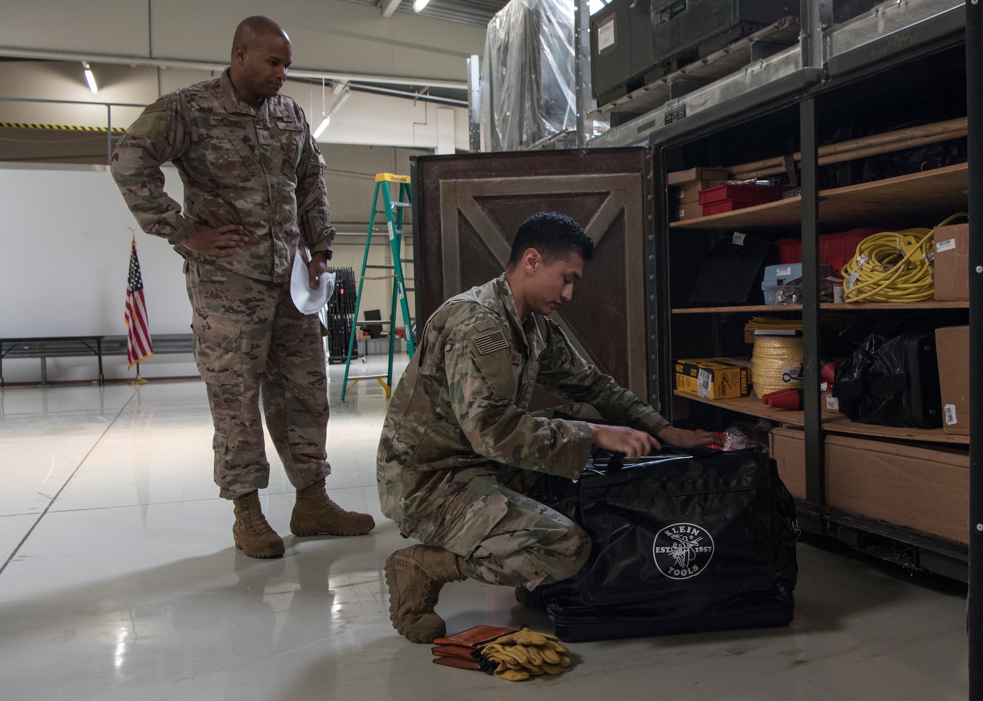 U.S. Air Force Tech. Sgt. Graeme Clouden, left, and Staff Sgt. Abraham Farias, 786th Civil Engineer Squadron expeditionary engineering training managers, inspect a supply bag for CE linemen at Ramstein Air Base, Germany, April 23, 2020