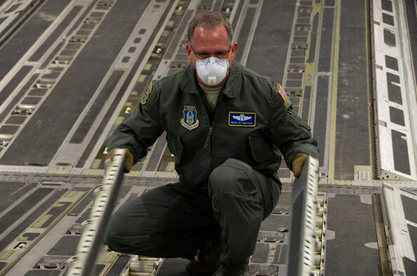 Airman flips cargo rollers on aircraft