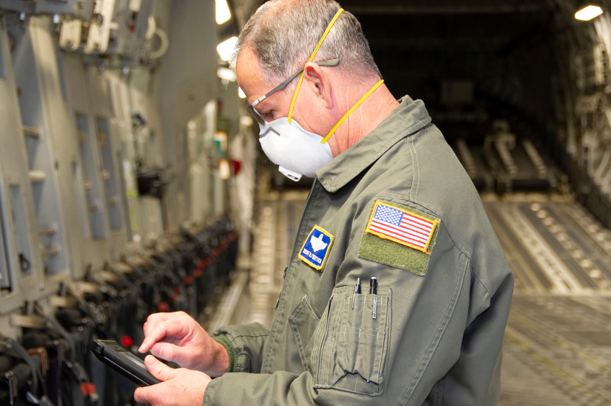 Aircrew reviews checklists on ipad on aircraft