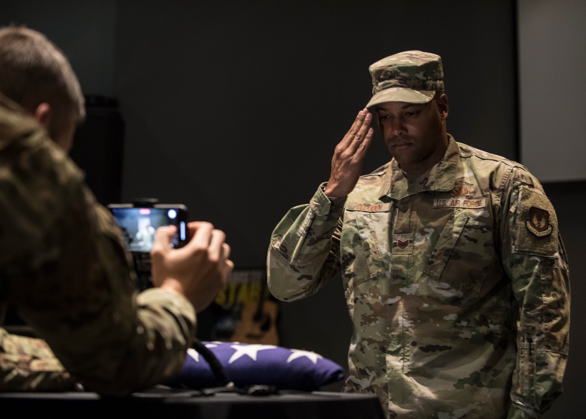 U.S. Air Force Tech. Sgt. Graeme Clouden, 786th Civil Engineer Squadron expeditionary engineering training manager, salutes a folded flag for Retired Maj. Ralph L. Turner, Tuskegee Airman, at Ramstein Air Base, Germany, April 24, 2020.