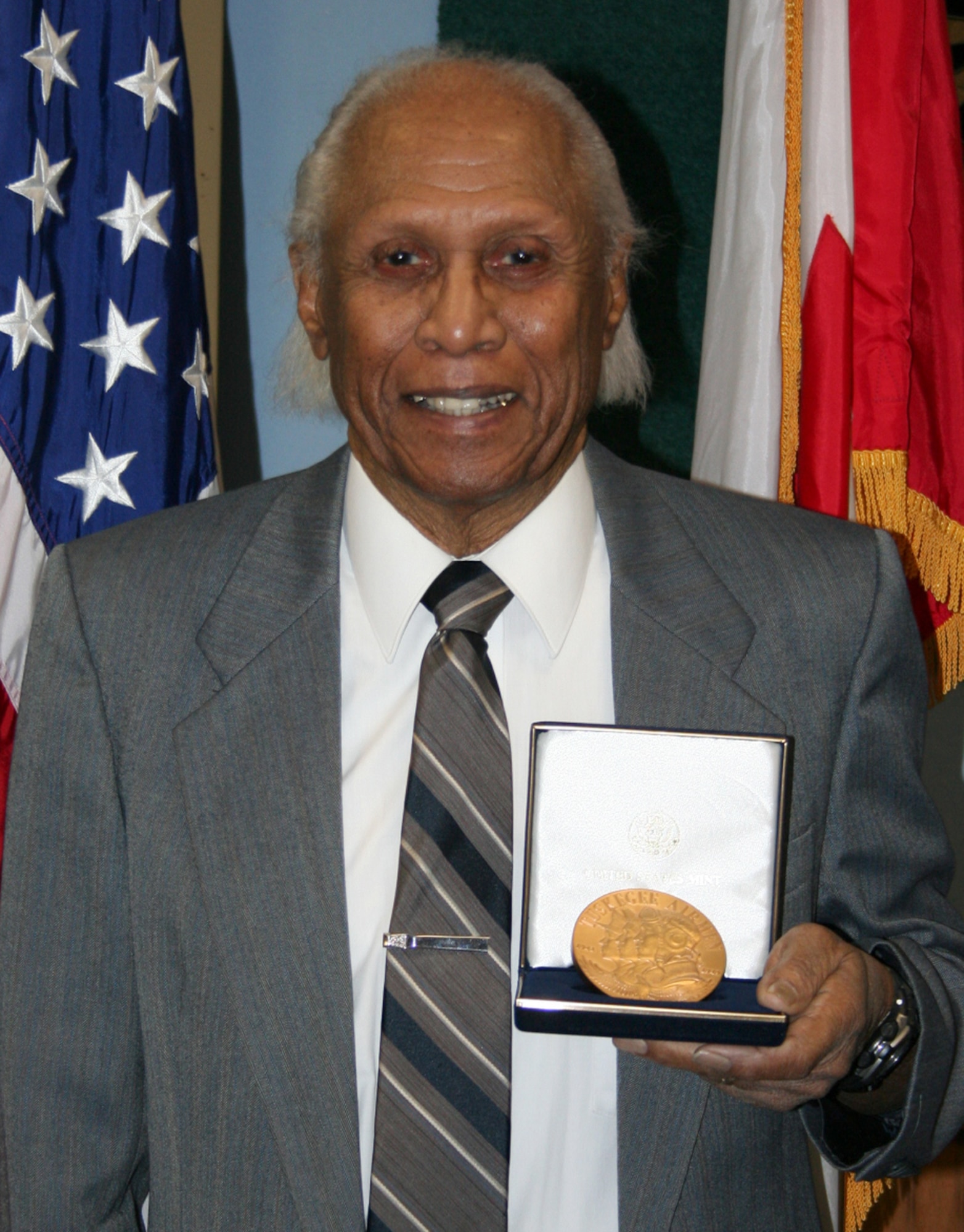 Retired U.S. Air Force Maj. Ralph L. Turner, a Tuskegee Airman, stands with his Congressional Gold Medal Feb. 19, 2008.