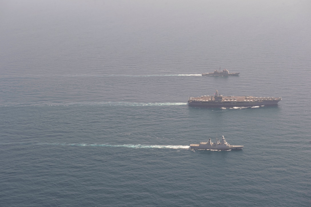 U.S. and French naval ships transit the sea.