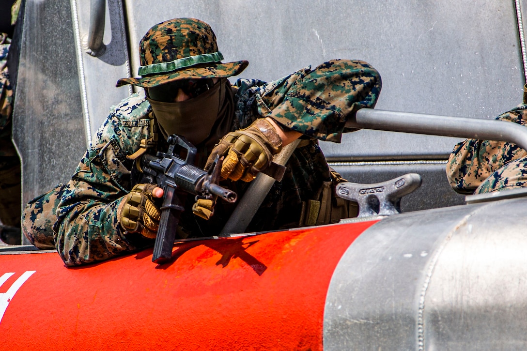 A U.S. Marine prepares to exit a boat during an amphibious assault exercise on Marine Corps Base Hawaii, April 28, 2020.