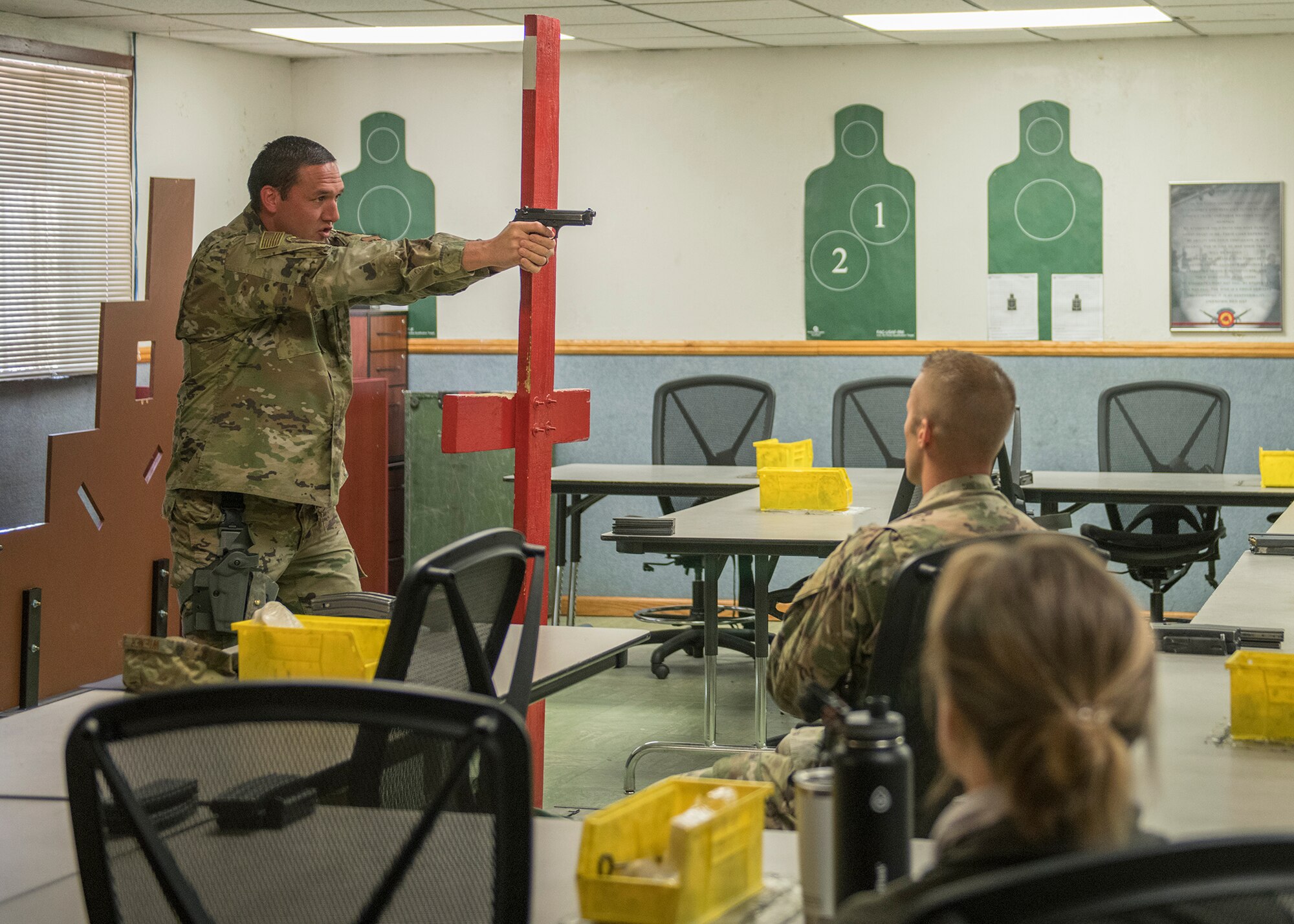 Staff Sgt. Brent Pico, 56th Security Forces Squadron Combat Arms Training and Maintenance flight instructor, demonstrates a weapon handling technique to a class April 15, 2020, at Luke Air Force Base, Ariz.