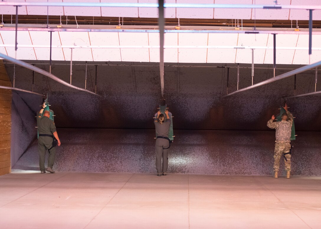 Lt. Col. Bailyn Beck, 56th Training Squadron assistant director of operations (left), Capt. Brittany Dippel, 309th Fighter Squadron student pilot, and Chief Master Sgt. Joshua Wiener, 56th Maintenance Group superintendent, recover targets April 15, 2020, at the Combat Arms Training and Maintenance facility on Luke Air Force Base, Ariz.