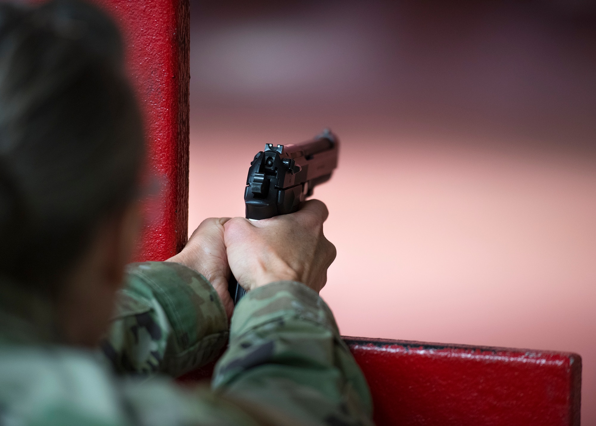 Lt. Col. Deborah Davidson, 341st Medical Operations Squadron commander, prepares to fire an M9 pistol April 15, 2020, at the Combat Arms Training and Maintenance facility on Luke Air Force Base, Ariz.