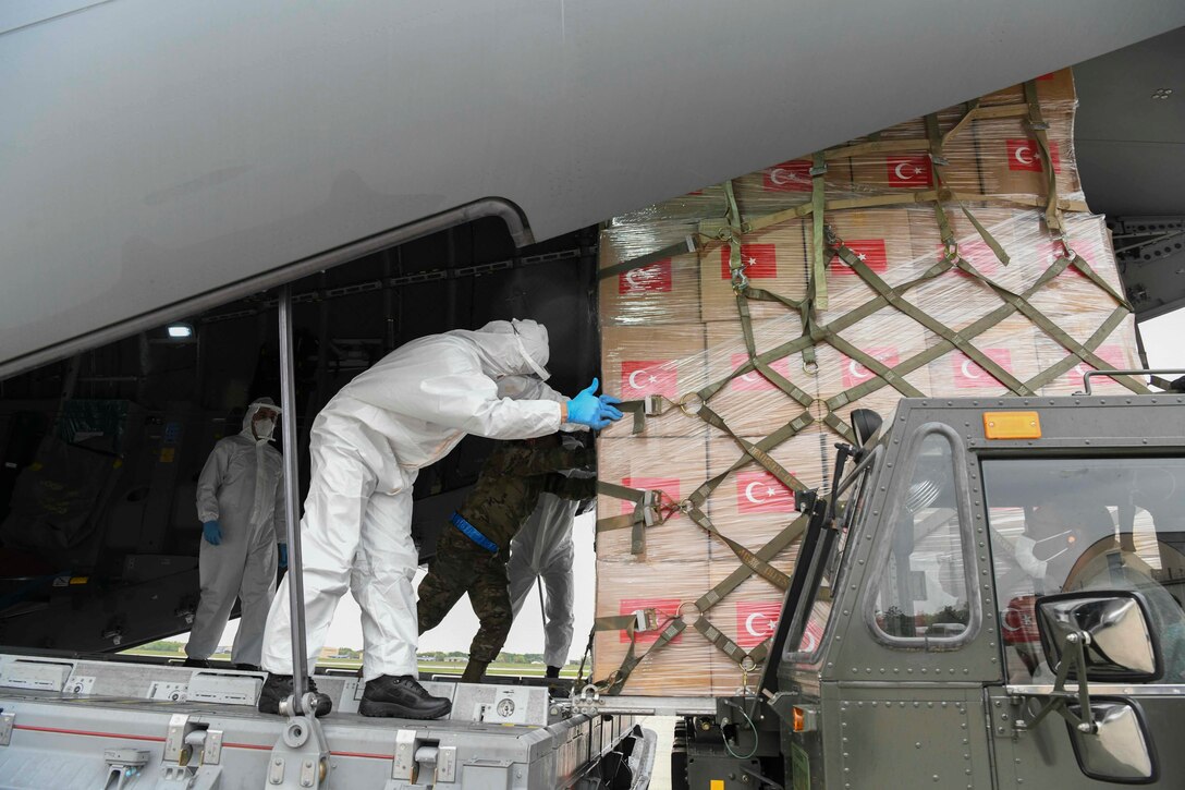 Turkish and U.S. Air Force crew members unload medical supplies from a Turkish Airbus A400M Atlas.