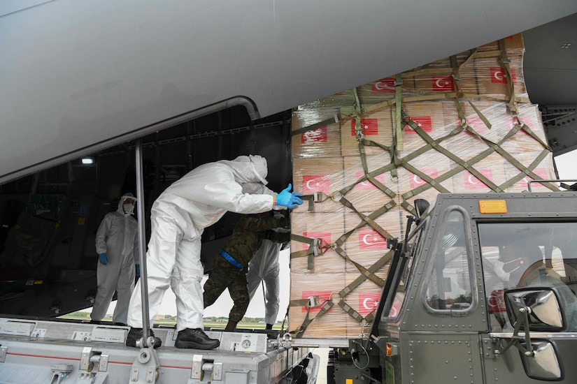 Turkish and U.S. Air Force crew members unload medical supplies from a Turkish Airbus A400M Atlas.
