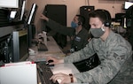 Senior Airman Ward Seymour, foreground, and 1st Lt. Quinn Tilley of the 224th Air Defense Group, New York National Guard, Rome, New York, prepare for the April 28, 2020, America Strong New York City flyover. The Air Force Thunderbird and Navy Blue Angel demonstration aircraft honored health care personnel and essential workers in the New York metro area. The 224th ADG provided tactical control, airspace deconfliction and coordinated refueling tankers for the flyover.