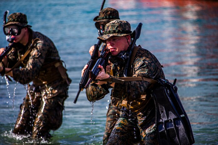 U.S. Marines with Bravo Company, 1st Battalion, 3rd Marine Regiment, hit the shore during an amphibious assault exercise on Marine Corps Base Hawaii, April 28, 2020. Bravo Company conducted the boating event to increase proficiency in areas that are uncommon to infantry training within the Marine Corps while mitigating risks brought on by COVID-19. (U.S. Marine Corps photo by Lance Cpl. Jacob Wilson)