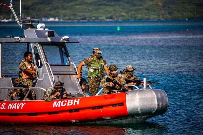 U.S. Marines with Bravo Company, 1st Battalion, 3rd Marine Regiment, prepare to attack the beach during an amphibious assault exercise on Marine Corps Base Hawaii, April 28, 2020. Bravo Company conducted the boating event to increase proficiency in areas that are uncommon to infantry training within the Marine Corps while mitigating risks brought on by COVID-19. (U.S. Marine Corps photo by Lance Cpl. Jacob Wilson)
