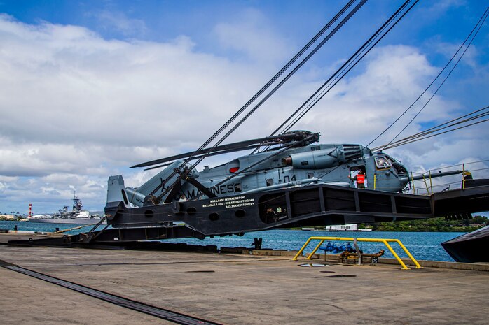 U.S. Marines with Marine Heavy Helicopter Squadron 463, Marine Aircraft Group 24, haul a CH-53E Super Stallion off the ramp of a vehicle carrier vessel on Joint Base Pearl Harbor-Hickam, April 24, 2020. HMH-463 offloaded a CH-53E following a maintenance operation overseas. (U.S. Marine Corps photo by Lance Cpl. Jacob Wilson)