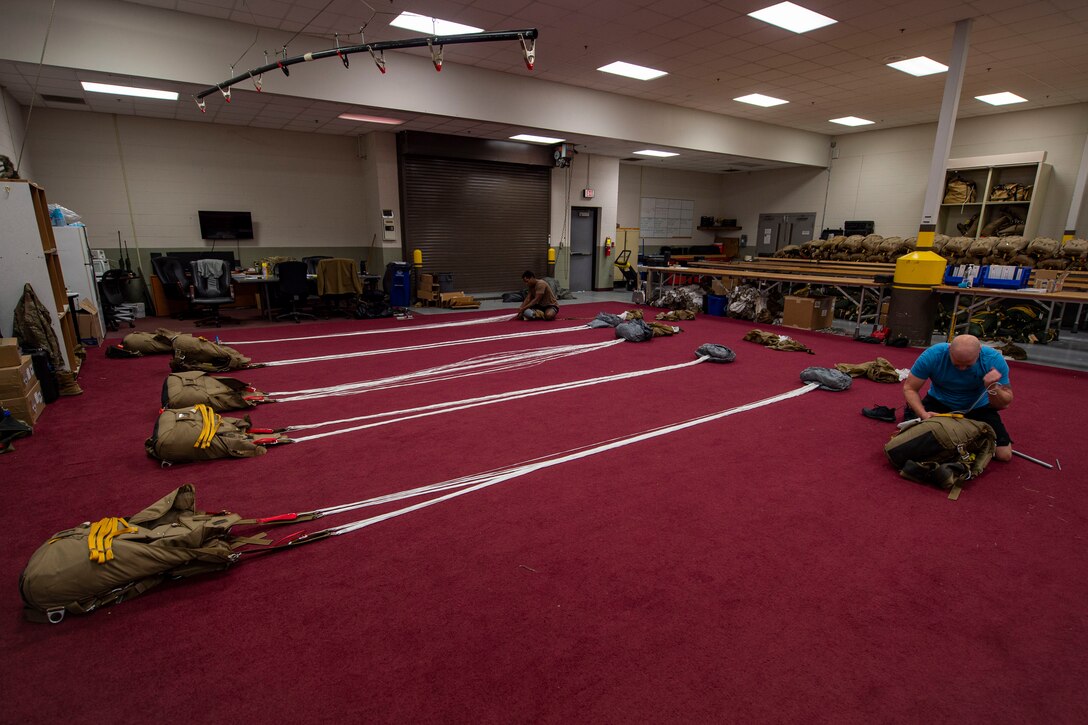 Photo of Airmen packing parachutes.