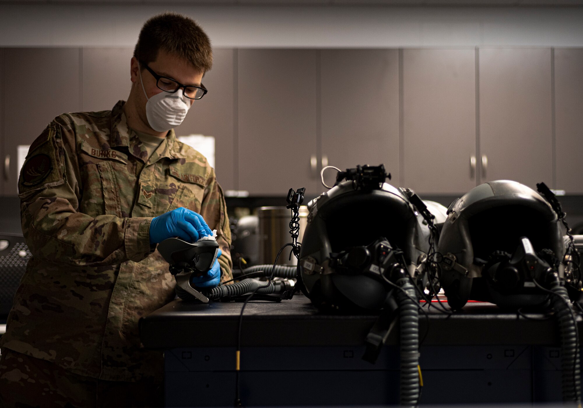 Photo of an Airman sanitizing an oxygen mask.