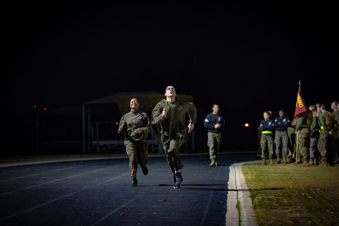 U.S. Marines and Sailors assigned to Headquarters and Headquarters Squadron (H&HS) participate in a squadron physical training (PT) session on Marine Corps Air Station (MCAS) Yuma, Ariz., Jan. 10, 2020. The PT session consisted of: burpees, crunches, flutter kicks, squats and running laps around the track. (U.S. Marine Corps photo by Lance Cpl. Gabrielle Sanders)