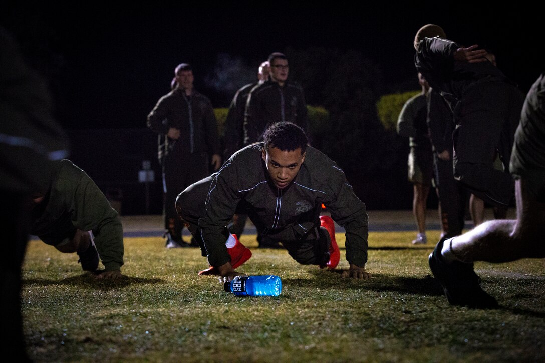 U.S. Marines and Sailors assigned to Headquarters and Headquarters Squadron (H&HS) participate in a squadron physical training (PT) session on Marine Corps Air Station (MCAS) Yuma, Ariz., Jan. 10, 2020. The PT session consisted of: burpees, crunches, flutter kicks, squats and running laps around the track. (U.S. Marine Corps photo by Lance Cpl. Gabrielle Sanders)