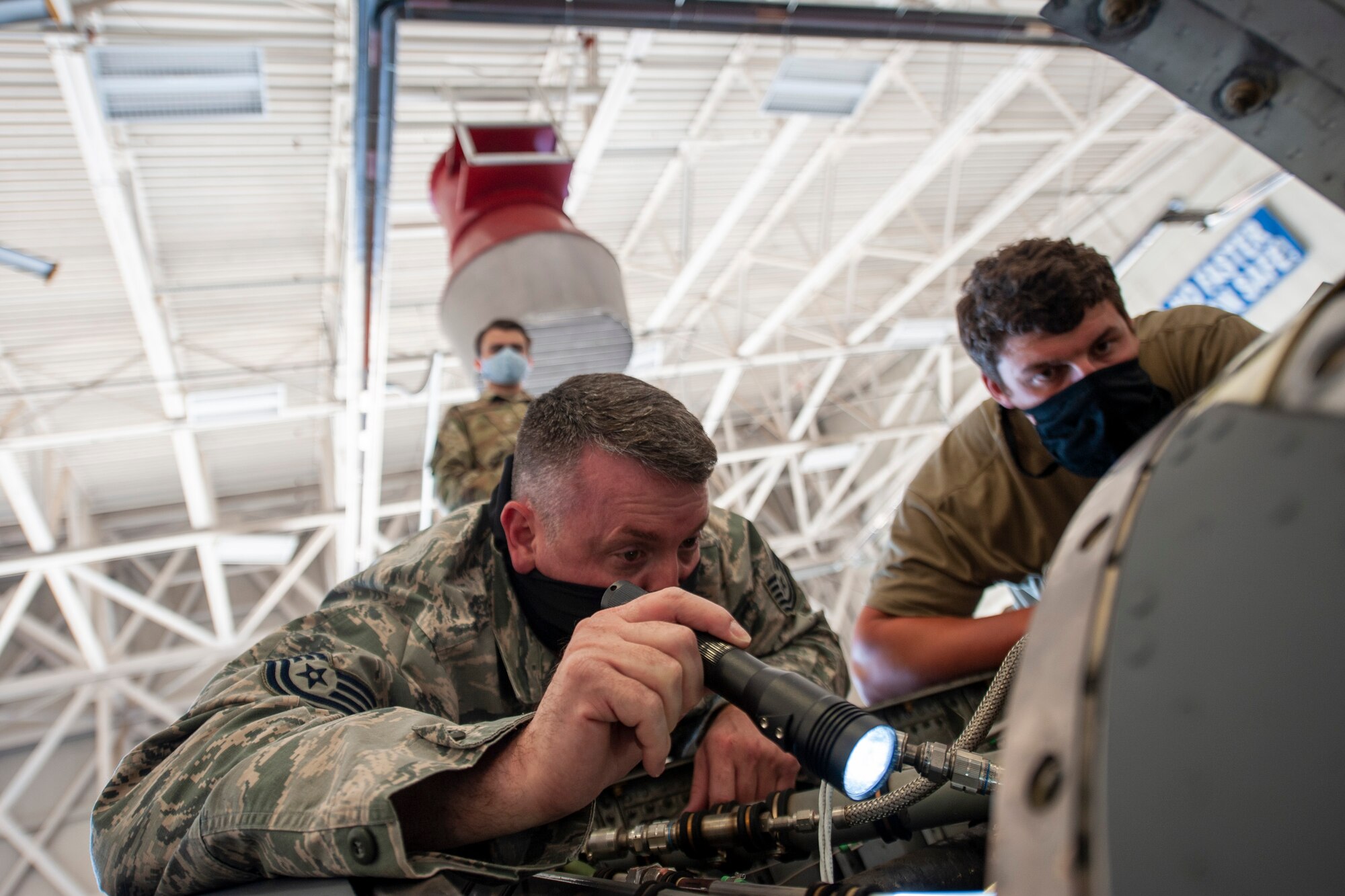A picture of Airmen looking into an aircraft.