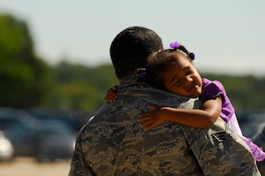Kaliyah, three, hugs her father U.S. Air Force Senior Airman Damien Williams.