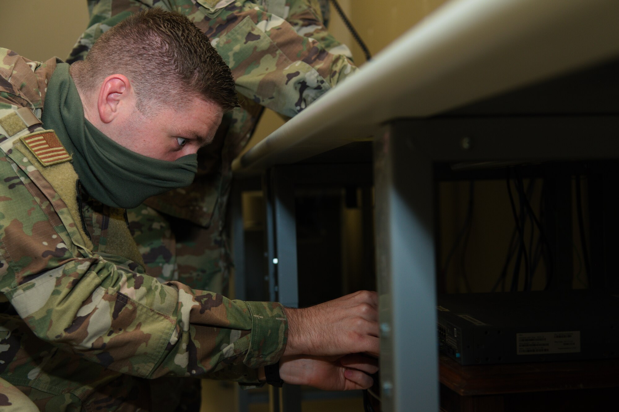 U.S. Air Force Senior Airman Clayton Hester, a 6th Communications Squadron (CS) executive communications specialist, checks connections on a network server at MacDill Air Force Base, Fla., Apr. 23, 2020.