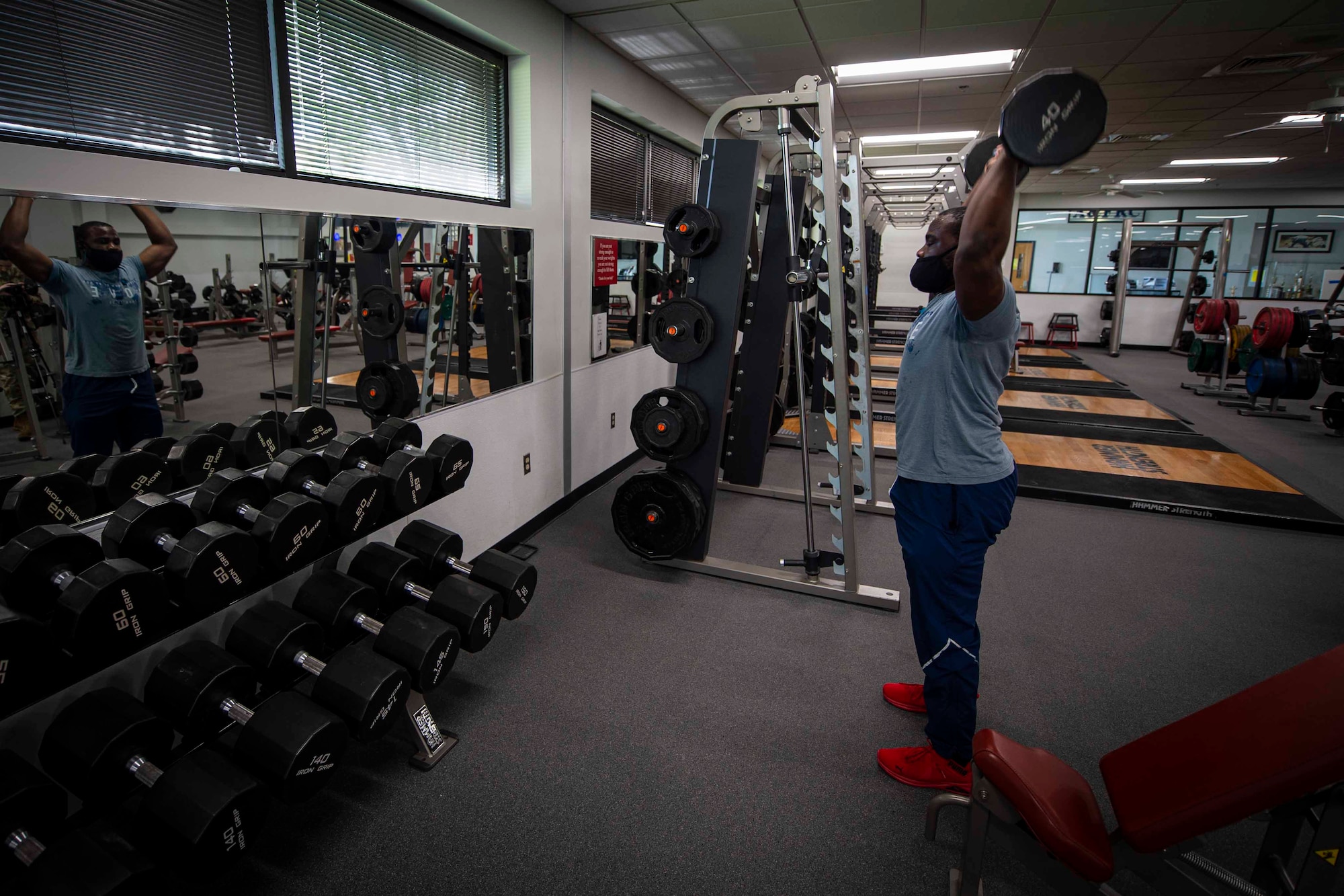Photo of an Airman performing a shoulder press.
