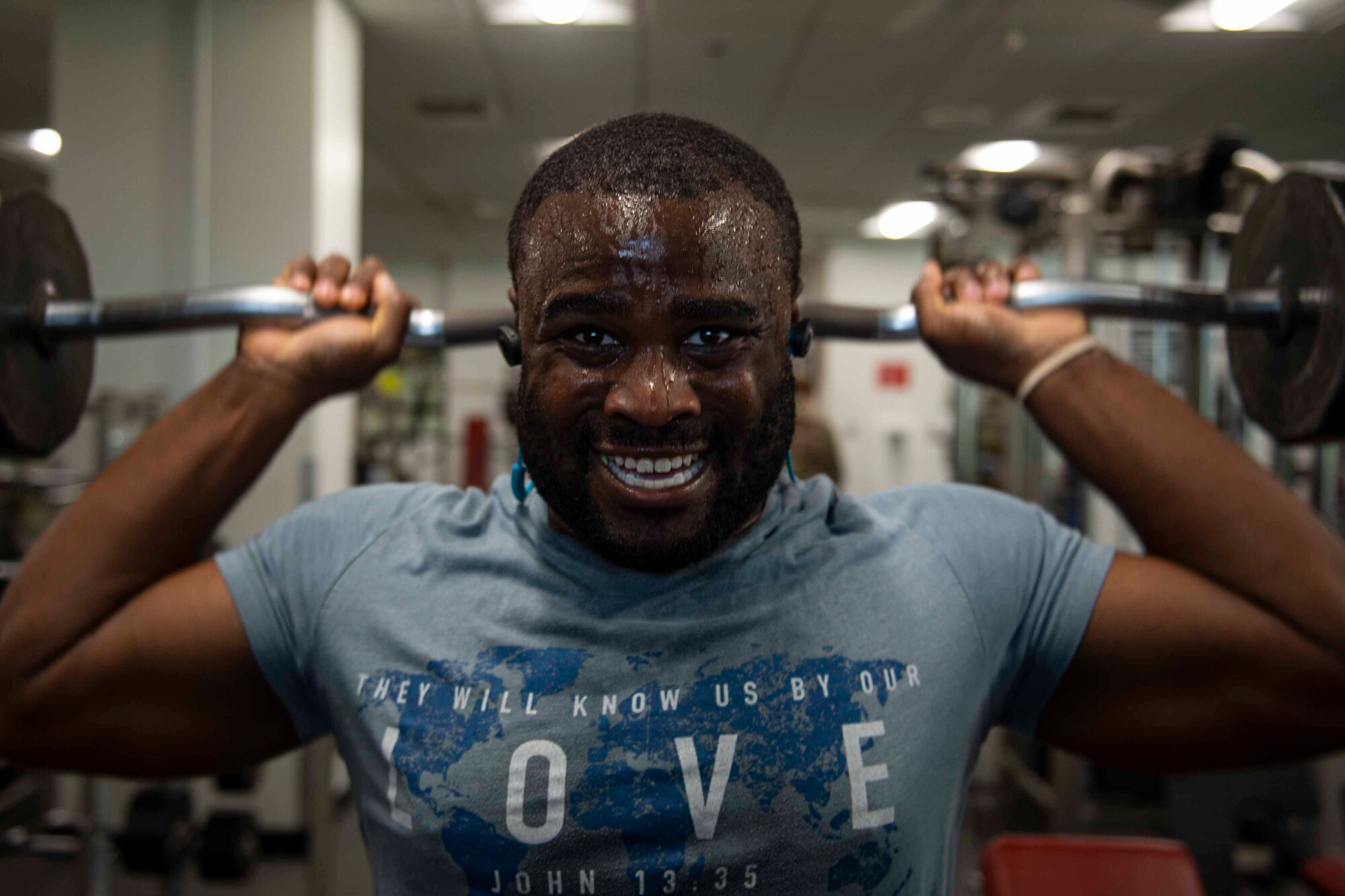 Photo of an Airman performing a military press.