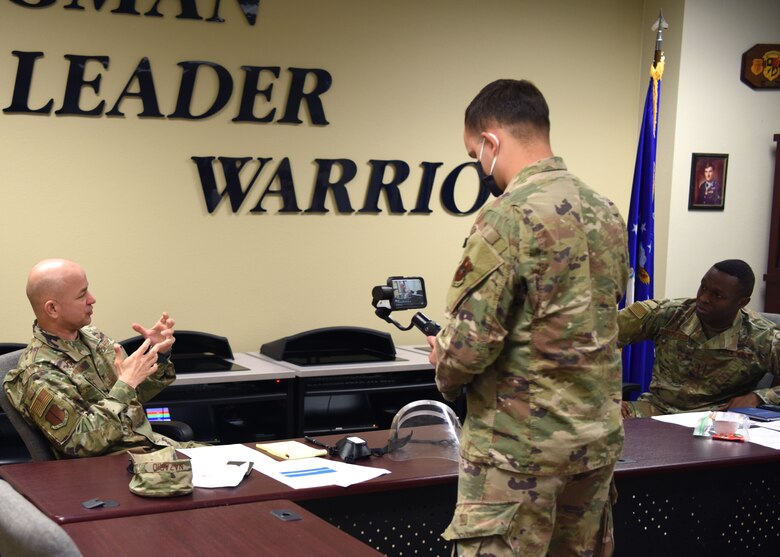 U.S. Air Force Senior Airman Deven Schultz, 17th Training Wing broadcast journalist, films Col. Andres Nazario, 17th TRW commander, discussing retiree access with Chief Master Sgt. Lavor Kirkpatrick, 17th TRW command chief, during the COVID-19 Virtual Town Hall on Goodfellow Air Force Base, Texas, April 29, 2020. The town hall was held to discuss the future of Goodfellow and answer questions from the base and surrounding community. (U.S. Air Force photo by Airman 1st Class Ethan Sherwood)