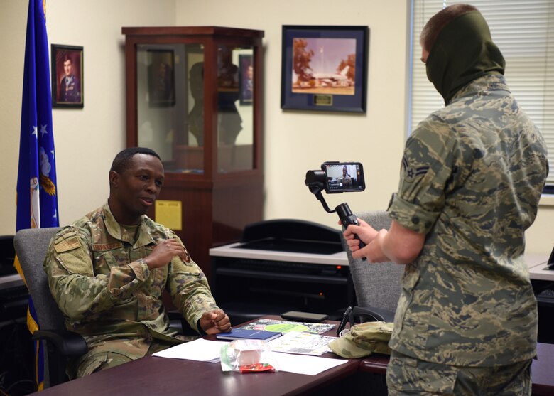 U.S. Air Force Airman 1st Class Michael Bowman, 17th Training Wing broadcast journalist, films Chief Master Sgt. Lavor Kirkpatrick, 17th TRW command chief, addressing the live stream during the COVID-19 Virtual Town Hall on Goodfellow Air Force Base, Texas, April 29, 2020. The virtual town hall allowed members to interact with base leadership without compromising health. (U.S. Air Force photo by Airman 1st Class Ethan Sherwood)