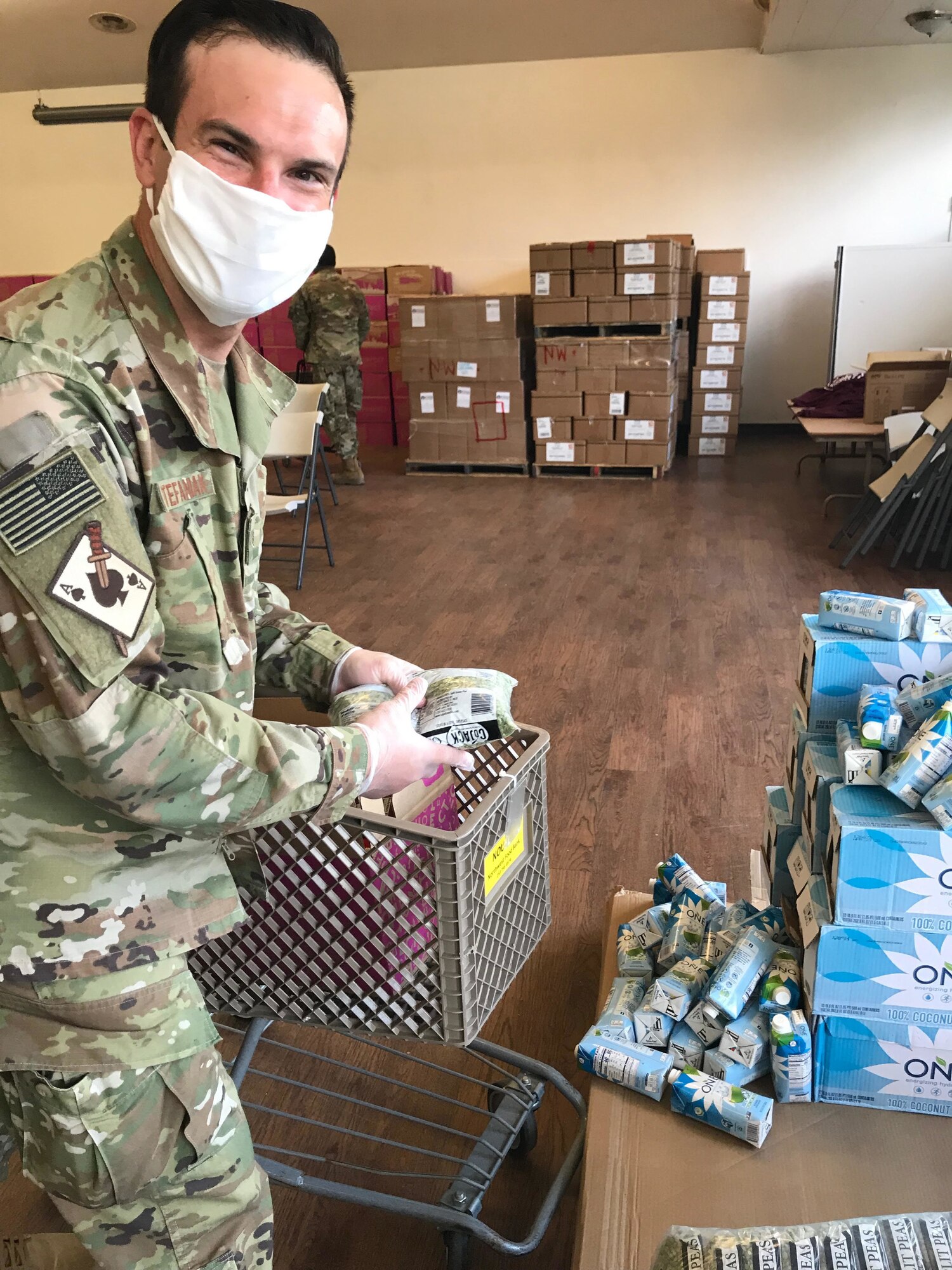 U.S. Air Force Staff Sgt. David Stefaniak, a boom operator with the Washington Air National Guard's 116th Air Refueling Squadron, sorts food at the Issaquah Food Bank April 15, 2020. Stefaniak is supporting multiple food banks in the Puget Sound area as part of the state's COVID-19 response.