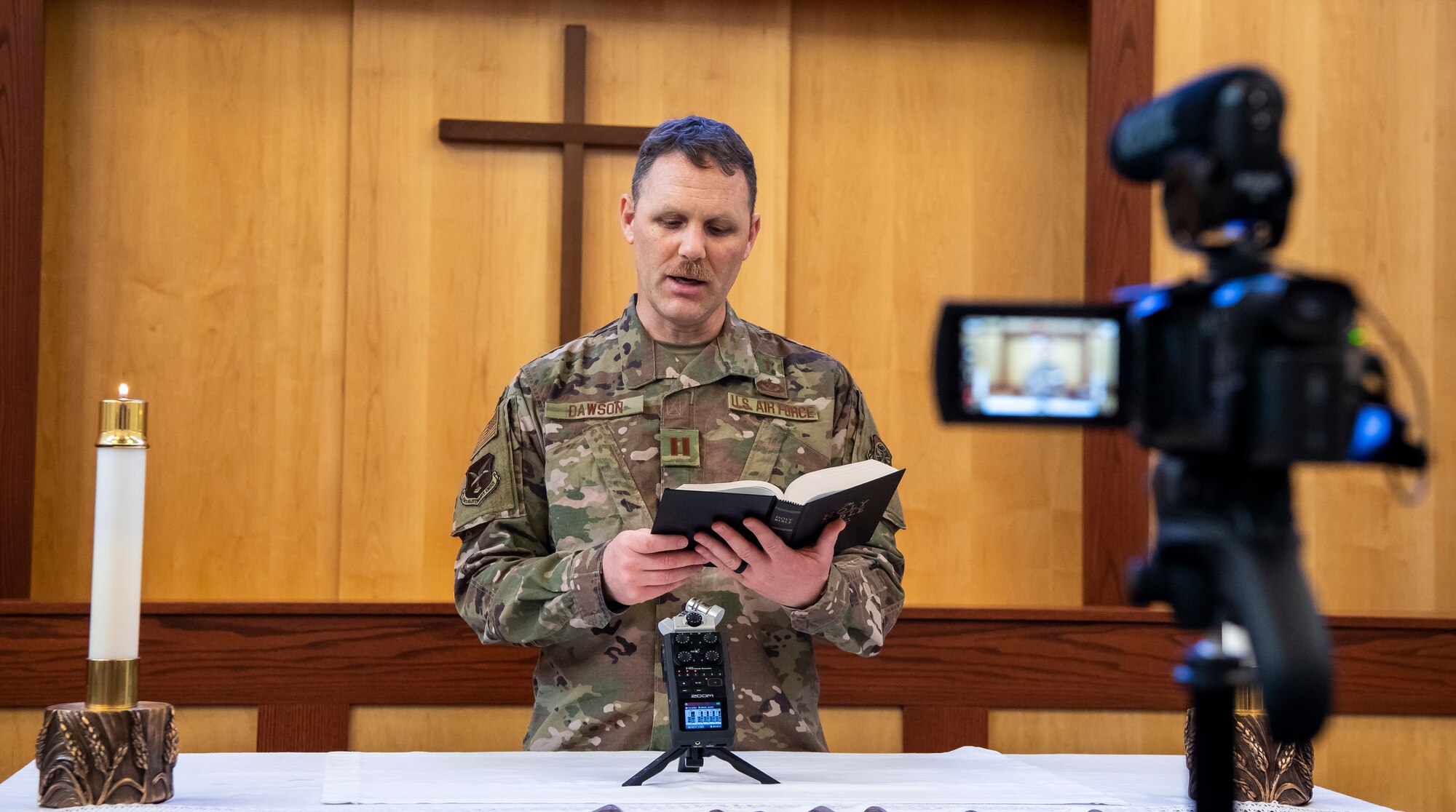 Chaplain (Capt.) Jonathan Dawson, 436th Airlift Wing chaplain, speaks during a service recording April 25, 2020, at Chapel 1 on Dover Air Force Base, Delaware. The recordings are created during the week and aired on Sunday due to COVID-19 restrictions. The recordings allow the chapel to provide services while ensuring people's safety. (U.S. Air Force photo by Senior Airman Christopher Quail)