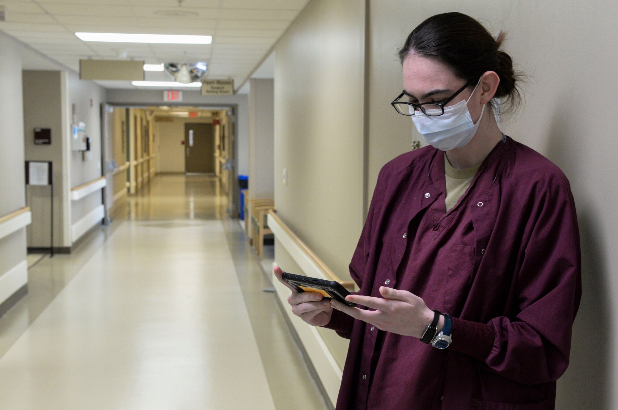 Airman 1st Class Rehanna Payne, a medical technician, uses medical monitoring technology called the Battlefield Assisted Trauma Distributed Observation Kit, or BATDOK, to check the vitals of a patient while she stands in a hallway of the Wright-Patterson Medical Center April 28. The Air Force Research Laboratory adapted this technology, originally developed for the pararescue community, for medical facilities during the COVID-19 pandemic. (U.S. Air Force photo by Wesley Farnsworth)