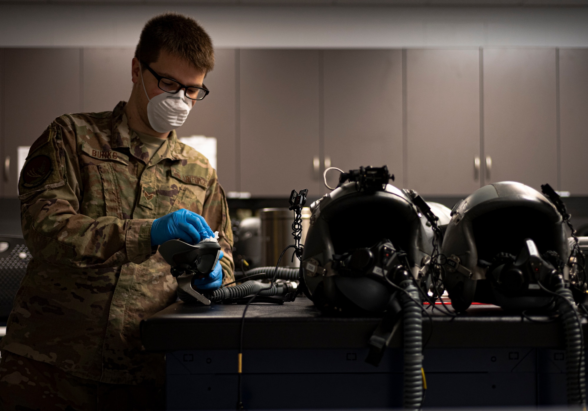 Photo of an Airman sanitizing an oxygen mask.