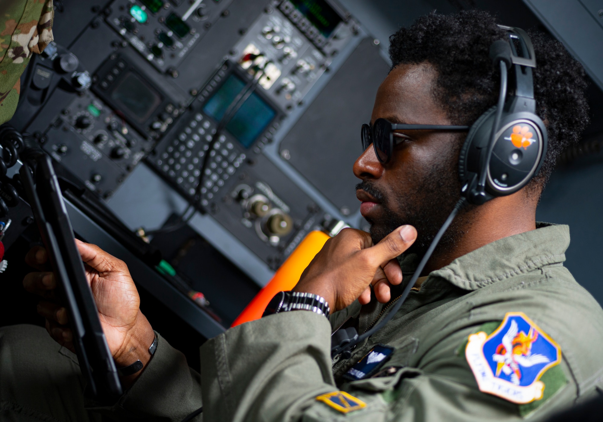 Photo of an Airman looking over a tablet before a flight.