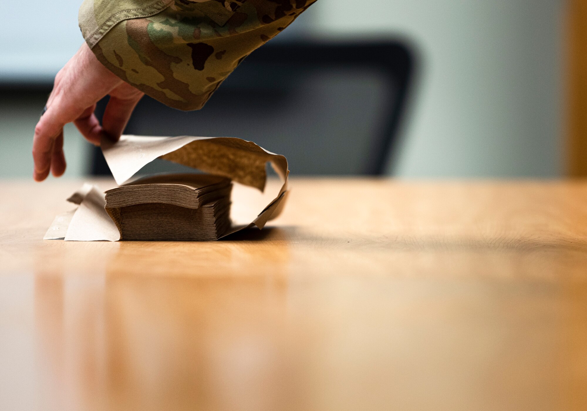 Photo of an Airman grabbing a paper towel.