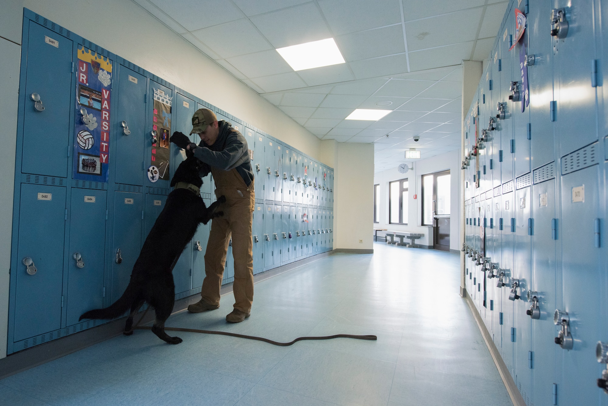 Photo of a man playing with a dog.