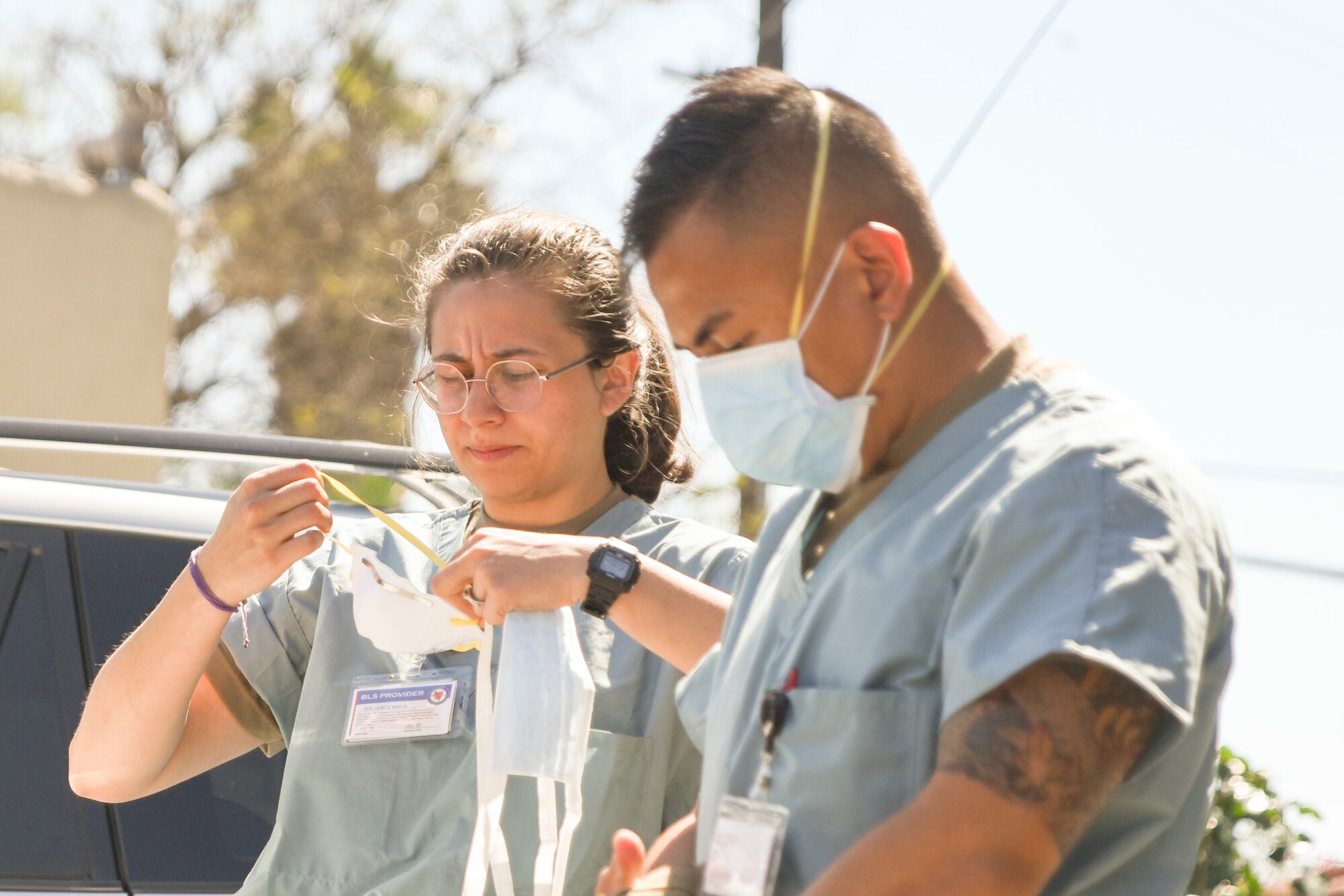 U.S. Army Spc. Makayla Montz and Pfc. Marc Jules Ocampo, California National Guard medical support team members, prepare to work at a skilled nursing facility in Southern California April 29, 2020. The medical support team is supporting staff at the facility, sharing best practices, and providing patient care for non-COVID-19 patients.