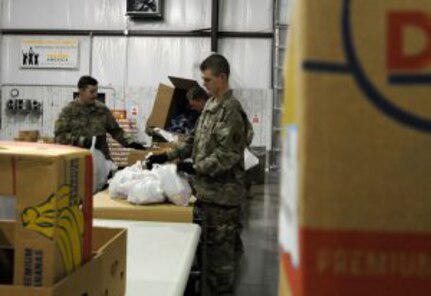 Soldiers with the 1123rd Sapper Company, Kentucky National Guard, load bags of food for children in support of Feeding America, Kentucky’s Heartland in Elizabethtown, Kentucky. The food bank faced increased demand at the same time its volunteers were forced to stay home to avoid the spread of COVID-19.