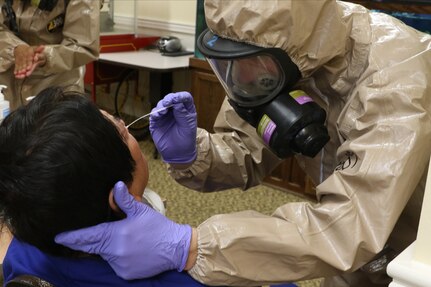 Virginia National Guard Soldiers and Airmen collect samples for COVID-19 testing of staff members at a long-term care facility April 28, 2020. VNG support provides additional capacity to localities through the Virginia Department of Health to get more people properly tested, and they are also delivering the samples for evaluation.