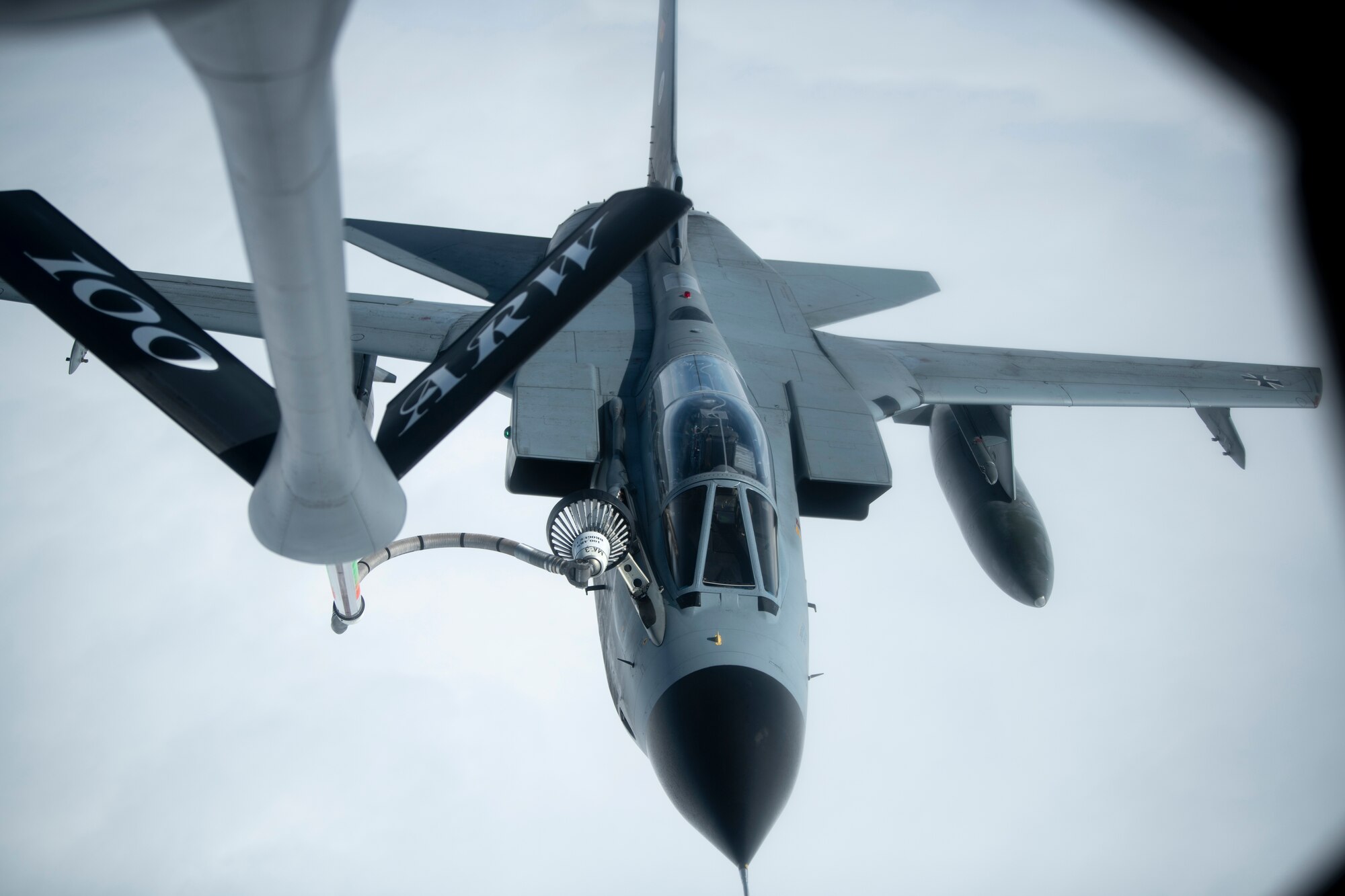 A German air force Tornado from the Tactical Air Force Squadron 51, Schleswig Air Base, Germany, receives fuel from a U.S. Air Force KC-135 Stratotanker from the 100th Air Refueling Wing, RAF Mildenhall, England, over Germany, April 29, 2020. The 100th Air Refueling Wing provides unrivaled air refueling support throughout the European and African areas of responsibility. (U.S. Air Force photo by Tech. Sgt. Emerson Nuñez)
