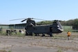 Team members at the U.S. Army Medical Materiel Center-Europe assist in unloading a Chinook helicopter carrying equipment for the 3rd Combat Aviation Brigade, 3rd Infantry Division on April 22. The 3rd CAB received dozens of mission-essential equipment replacements, including ventilators and defibrillators during the stopover.