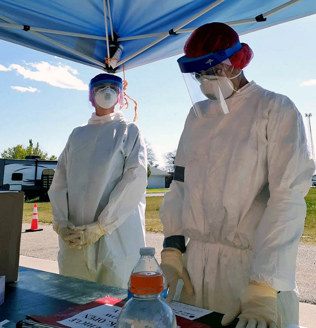 Staff Sgt. Carly Colletti (left) and Senior Airman Janie Terrazas (right), Air National Guard members with the 149th Fighter Wing, administer tests at a community-based testing facility in Friona, Texas, April 24