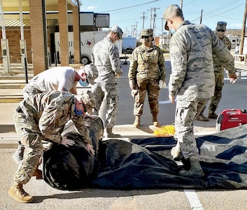 Air National Guard members with the 149th Fighter Wing break down a testing station at a community-based testing facility in Dumas, Texas, April 23