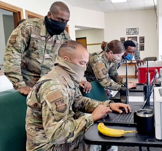 (From left) Staff Sgt. Chris Saenz, Staff Sgt. Anthony Guiteau, Tech. Sgt. Amber Harrison, and Airman 1st Class Victor Toeh work the verification station at a community-based testing facility in Friona, Texas, April 24.