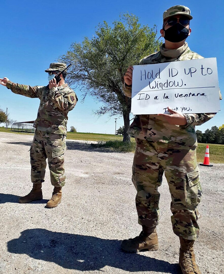 (From left) Senior Airman Josh Escarèno and Tech. Sgt. Andrew Guevara, Air National Guard members with the 149th Fighter Wing, provide test site procedures to drivers and passengers of incoming vehicles April 24, in Friona, Texas.