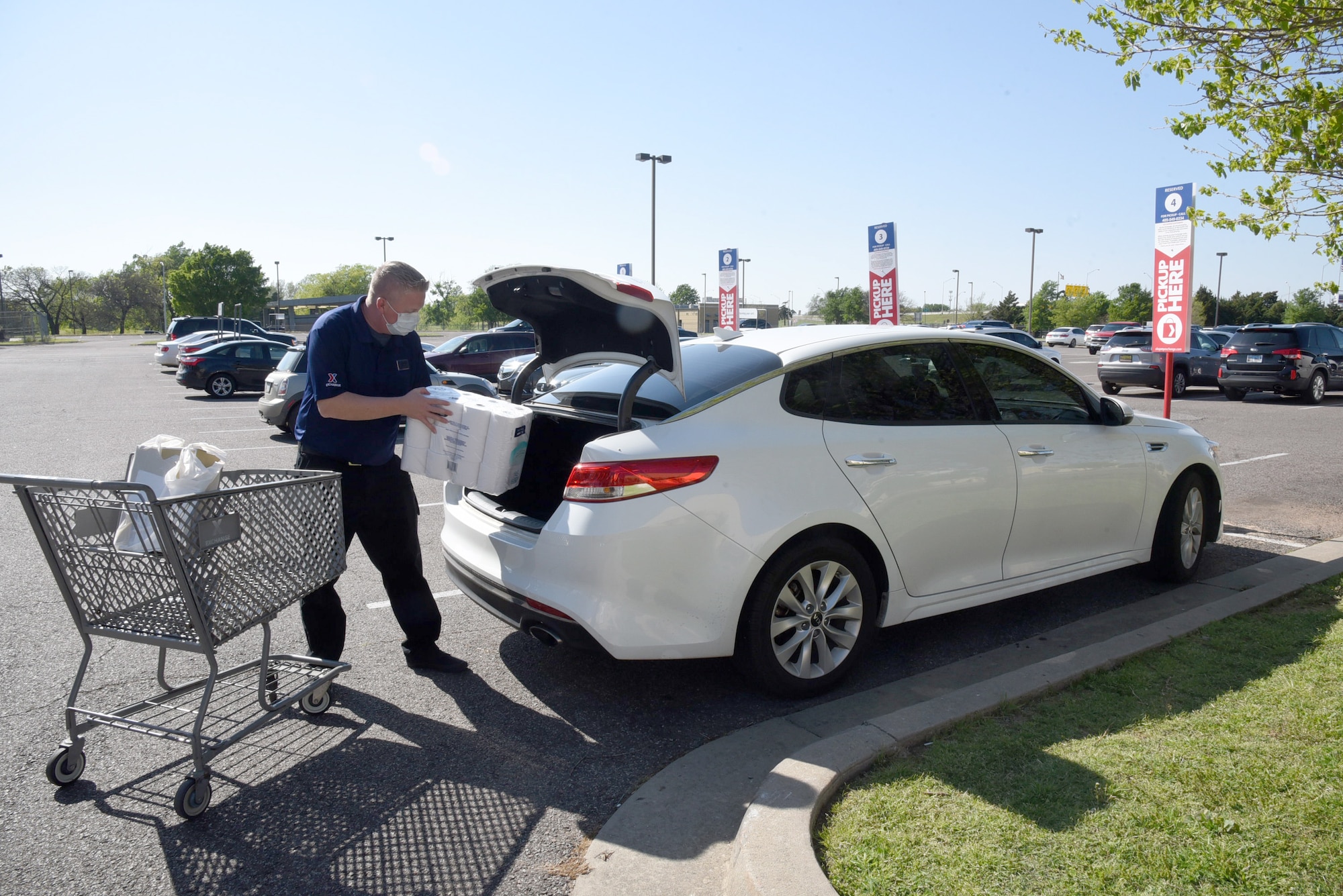 Brandon Swaller, the customer service supervisor, loads a customer's order into the vehicle at the Tinker Exchange's new curbside pickup area.