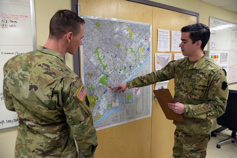 Task Force Saber officer in charge 1st Lt. Scott Dobson and non-commissioned officer in charge  Sgt. Justin Rinear look at map of Philadelphia and the area of operation on April 22, 2020 in anticipation of upcoming tasks. Pennsylvania National Guard’s Task Force Saber members have been preparing to support a mortuary-affairs mission as part of the PNG’s ongoing COVID-19 response efforts.