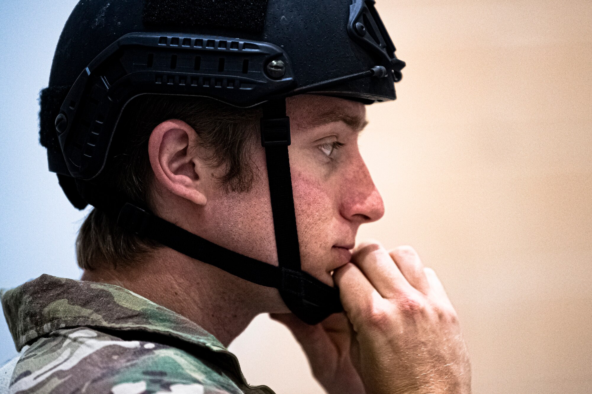 A photo of an Airman donning a helmet