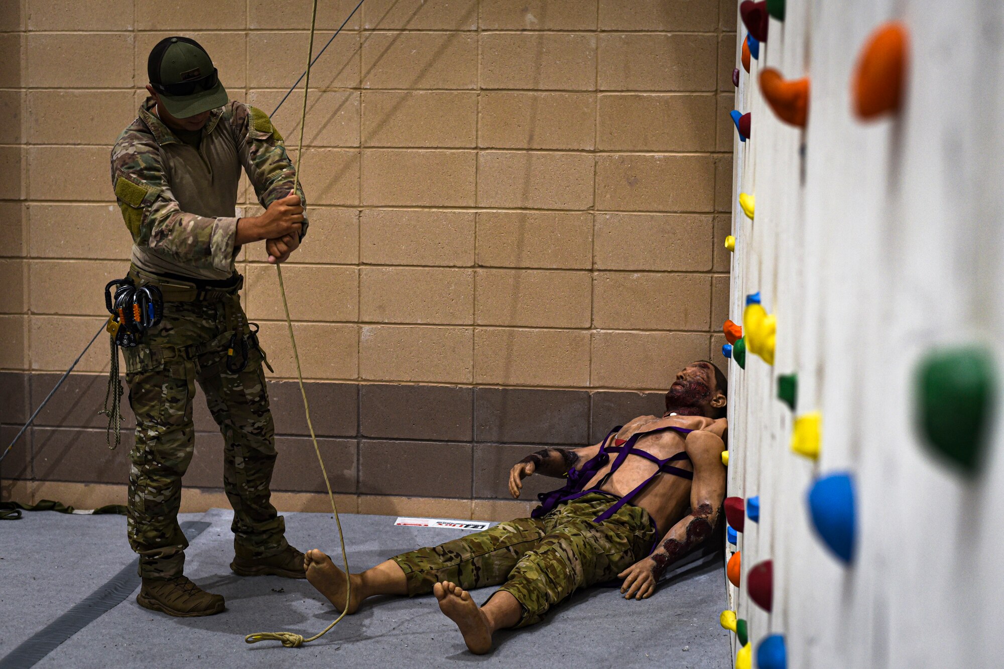 A photo of an Airman pulling a rope used for rappelling
